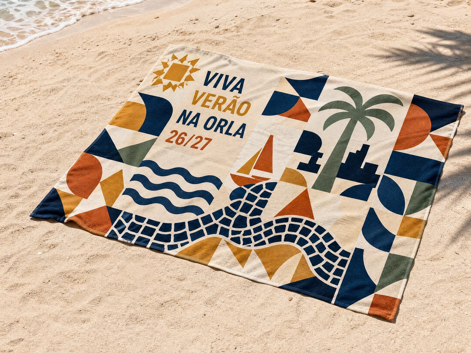 Canga estampada com a identidade do projeto sobre a areia